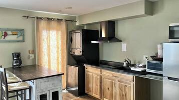 Fridge, microwave, coffee/tea maker, cookware/dishes/utensils