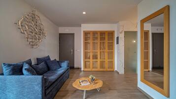 A modern living room with a sofa, coffee table, and decorative wall art.