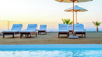 Seasonal outdoor pool, open 10:00 AM to 6:00 PM, pool umbrellas