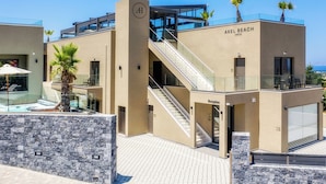 A modern hotel with a reception area, a staircase, and a pool area.