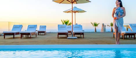 Seasonal outdoor pool, open 10:00 AM to 6:00 PM, pool umbrellas