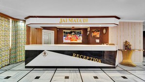 A reception desk with a sign reading "JAI MATA DI" and "RECEPTION" below it. - Hotel Bhawani International (Reasi)