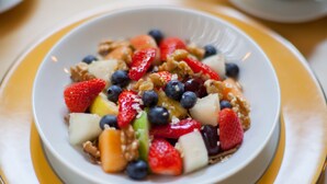 A bowl of fruit salad with strawberries, blueberries, and other fruits. - Hill View House (Dartmouth)