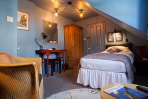 A bedroom with a bed, a desk, a chair, a wardrobe, and a mirror. - Hill View House (Dartmouth)