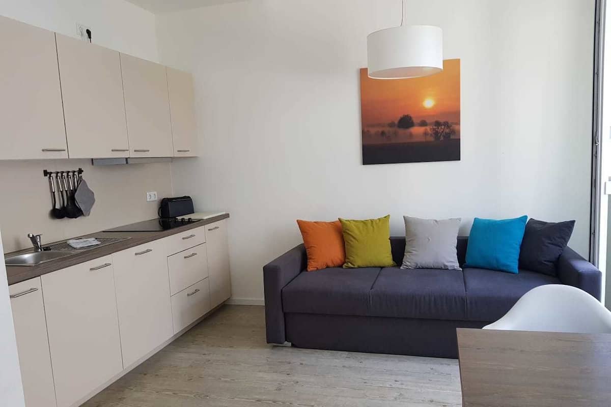 Basic Apartment, Courtyard View | Living area | Flat-screen TV