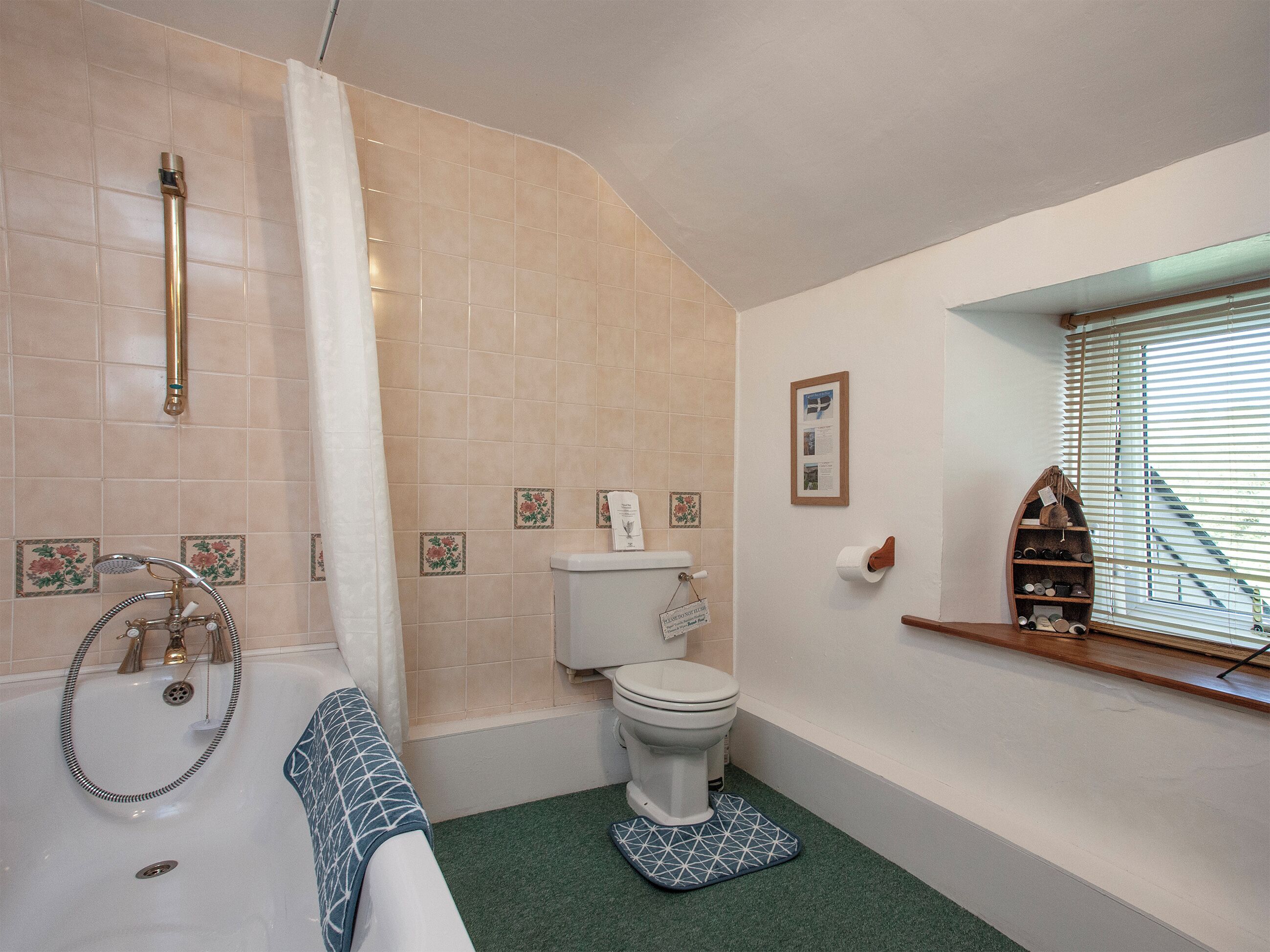 A bathroom with a bathtub, toilet, and shower.
