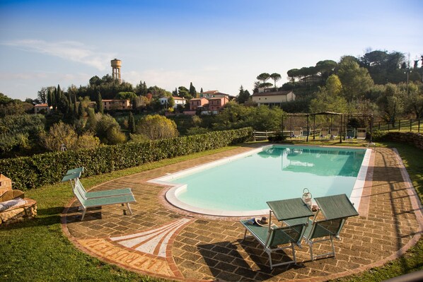 Seasonal outdoor pool, open 9:00 AM to 8:00 PM, pool umbrellas