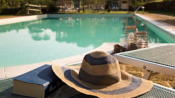 Seasonal outdoor pool, open 9:00 AM to 8:00 PM, pool umbrellas