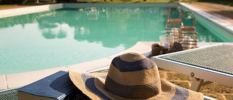 Seasonal outdoor pool, open 9:00 AM to 8:00 PM, pool umbrellas