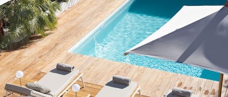 Seasonal outdoor pool, a heated pool, pool umbrellas, sun loungers