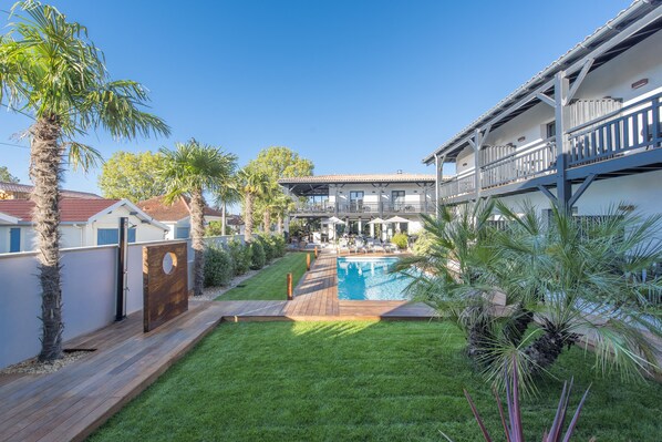 Seasonal outdoor pool, a heated pool, pool umbrellas, pool loungers