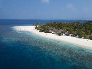 On the beach, white sand, sun loungers, beach towels
