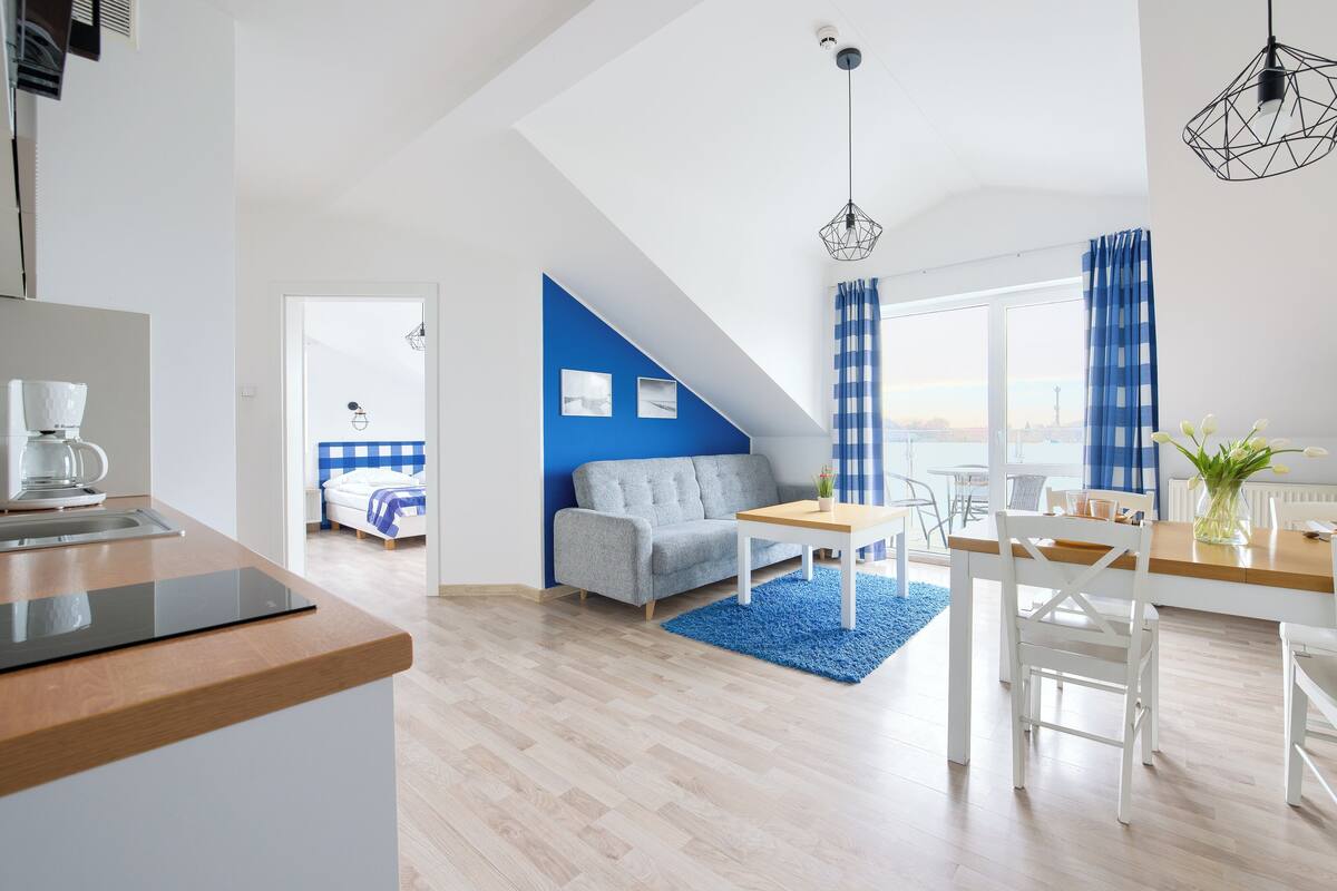 A modern apartment with a kitchen, dining area, and living room.