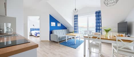 A modern apartment with a kitchen, dining area, and living room.