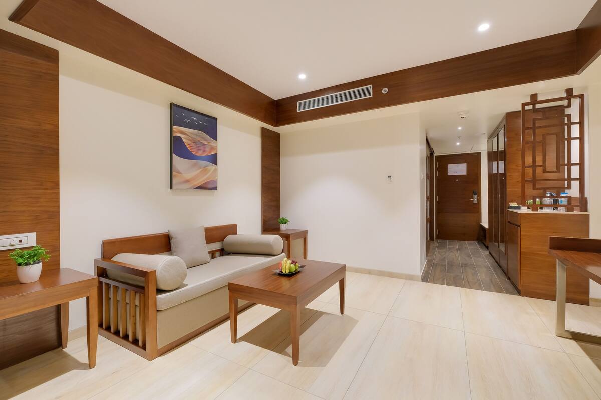 A modern living room with a sofa, coffee table, and a small side table with a plant.