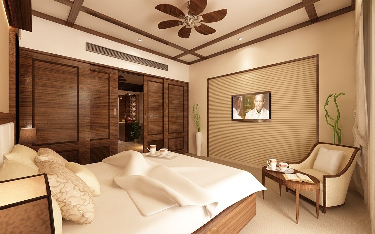 A modern hotel room with a large bed, a seating area with a table, and a ceiling fan.