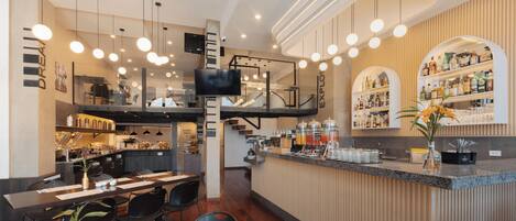 A modern bar area with a counter, seating, and a television.