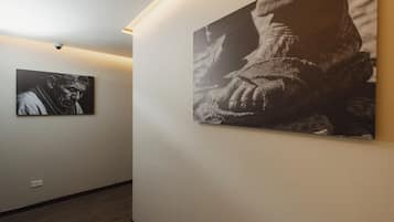 A hallway with two large black and white photographs on the walls.