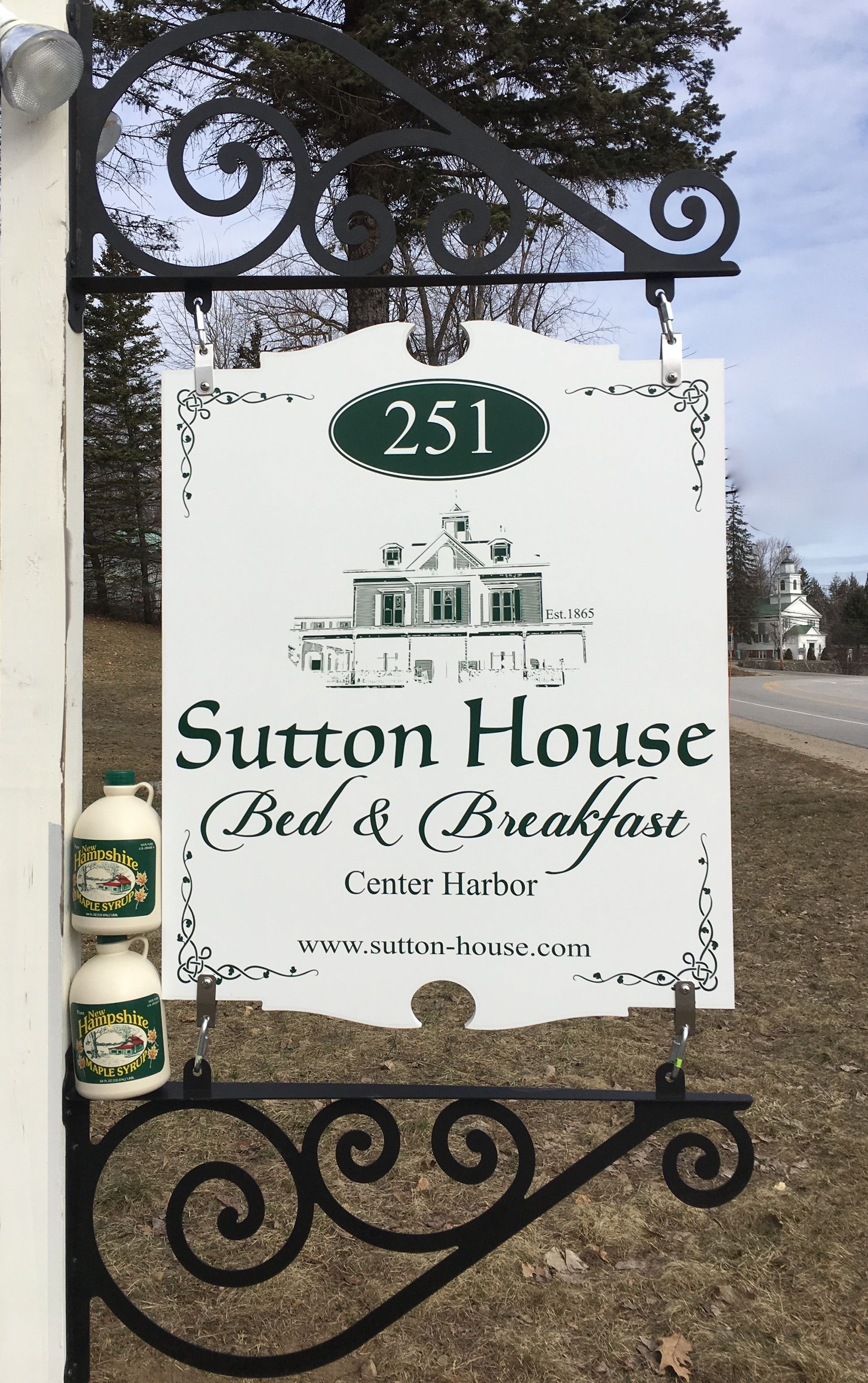 A sign for Sutton House Bed & Breakfast, featuring a house illustration and the number 251.