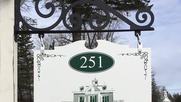 A sign for Sutton House Bed & Breakfast, featuring a house illustration and the number 251.