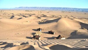 A desert landscape with sand dunes and tents. - Hostel take your time 4235 (Zagora)