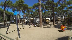 A campground with RVs, a swing set, and a playground. - Camping Interpals (Pals)
