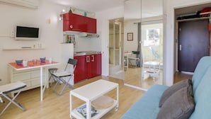 A compact living space with a kitchenette, a dining area, and a seating area with a sofa. - le Clos des Lavandes by Interhome (Bandol)