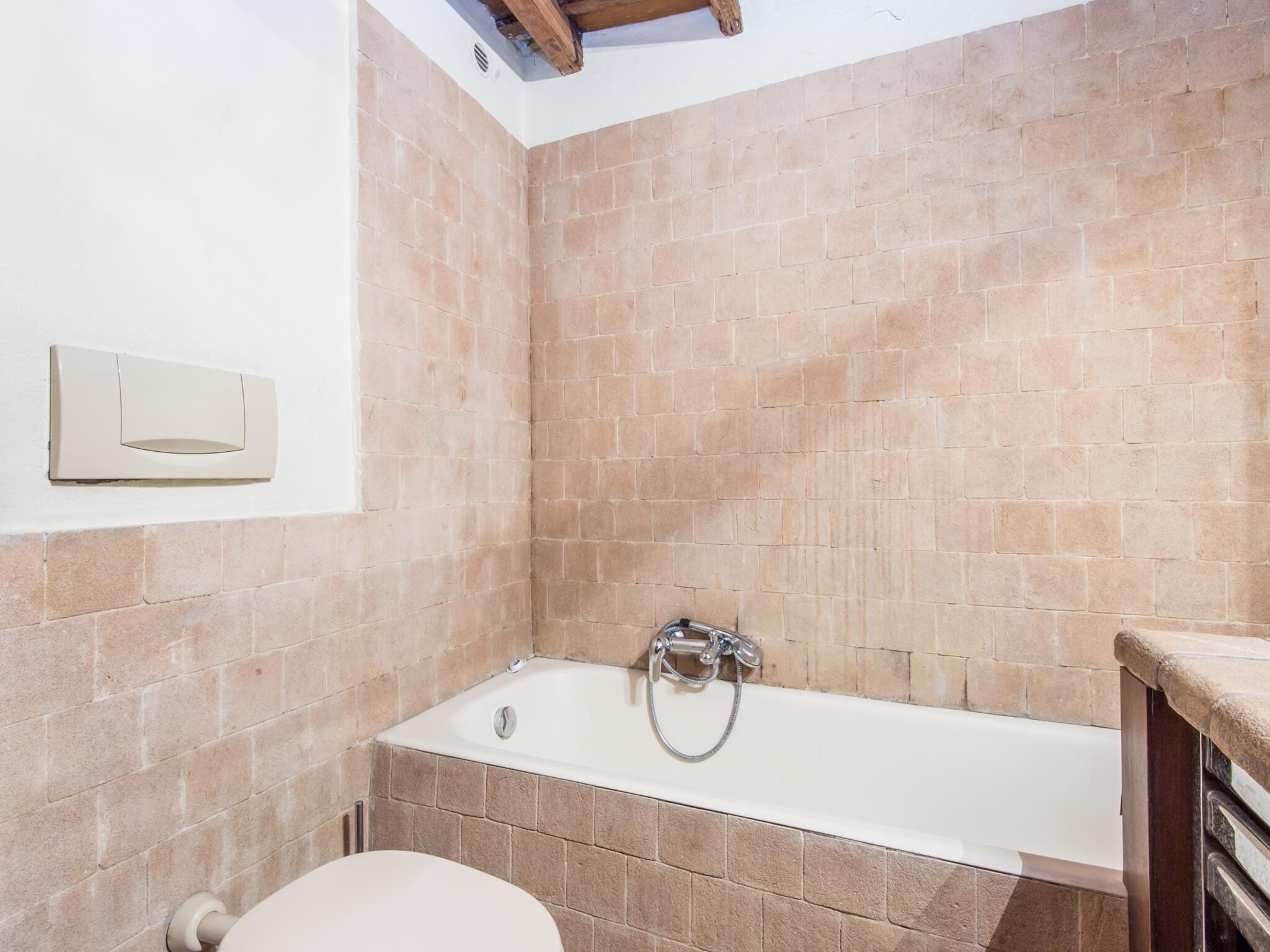 A bathroom with a bathtub, a toilet, and a shower.