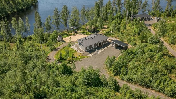 A lakeside property with a main building, a smaller structure, and a dock. - Riemukaari by Interhome (Pertunmaa)