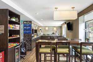 A modern kitchen with a central island, bar stools, and a dining area. - Best Western Brooklyn-Coney Island Inn (Brooklyn)