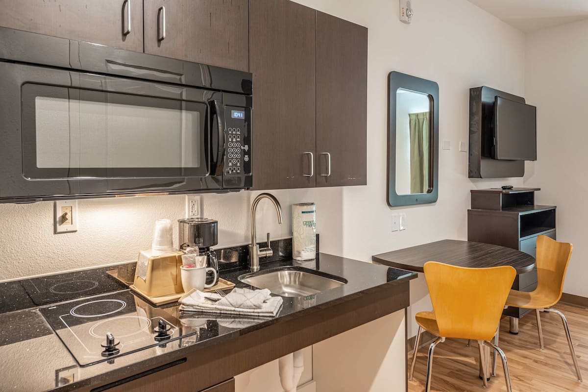 full-sized fridge, microwave, stovetop, coffee/tea maker