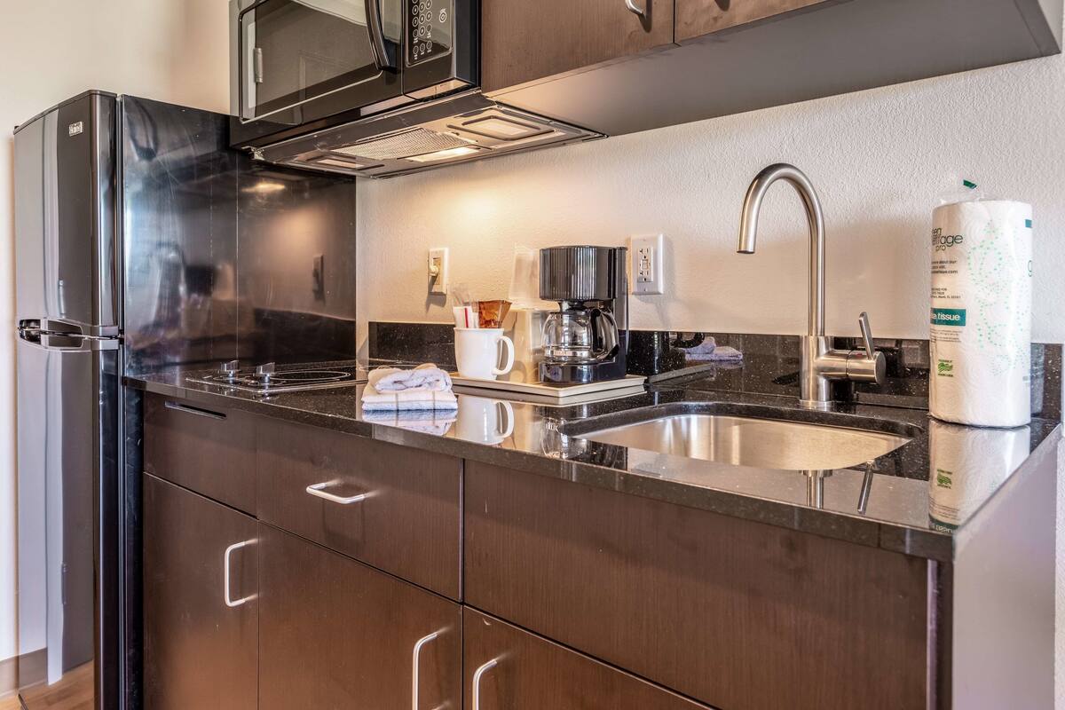 full-sized fridge, microwave, stovetop, coffee/tea maker