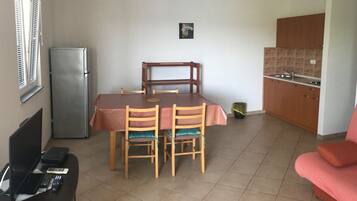 Classic Apartment, Sea View | Living area | TV