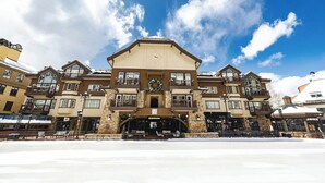 A multi-story hotel with a central entrance, balconies, and a stone facade. - Beaver Creek Village by Vail Resorts (Avon)