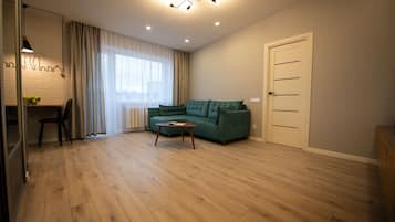 Comfort Apartment | Living area | 105-cm TV with satellite channels