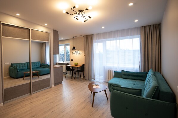 Comfort Apartment | Living area | 105-cm TV with satellite channels - Klaipeda Gate Apartments (Klaipeda)