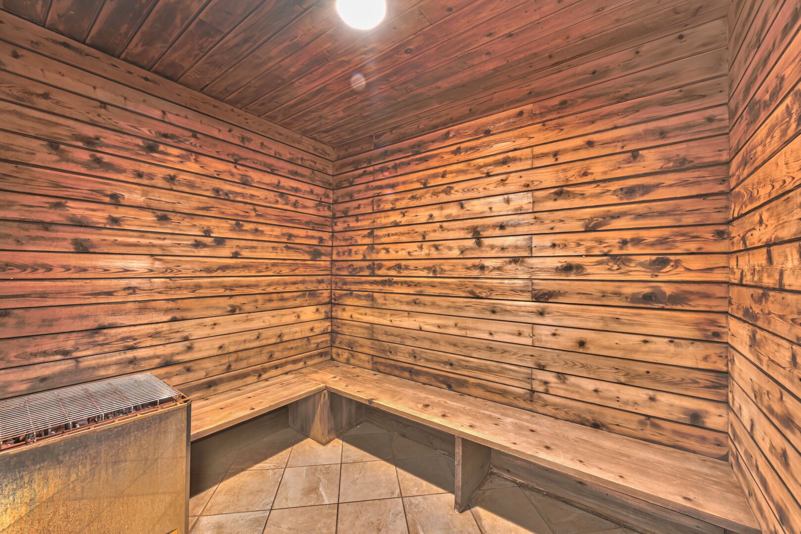 A sauna room with wooden walls and benches.