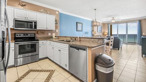 A modern kitchen with stainless steel appliances, a dishwasher, and a granite countertop.