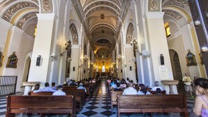 An interior of a church with wooden pews, a checkered floor, and ornate ceiling decorations. - Rio Mar Beach Resort - Time Magazine TOP 100 World's Greatest Places 2018 (Rio Grande)