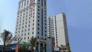 A multi-story hotel with a prominent red sign on the top. - Phoenix Hotel 2 (Sam Son)