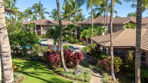 A resort with multiple buildings, a swimming pool, and lush tropical landscaping. - 🏖️2 Cal King Townhome | Pickleball + Pools | Near A-Bay (Waikoloa)