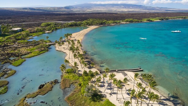 A coastal area with a beach, clear blue waters, and a mountainous background. - 🏖️2 Cal King Townhome | Pickleball + Pools | Near A-Bay (Waikoloa)