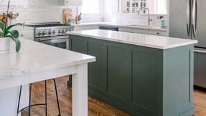 A modern kitchen with white cabinets, a stainless steel refrigerator, and a central island. - Large family home - walking distance to campus and square! (Oxford)