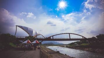 A bridge over a river with tents on the side.
