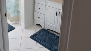 A bathroom with a white sink, two drawers, a mirror, and a shower curtain with a blue ocean design. - PRICE REDUCED Beautiful 3 Bedroom, 21/2 Bath Condo,walking distance to the beach (North Wildwood)