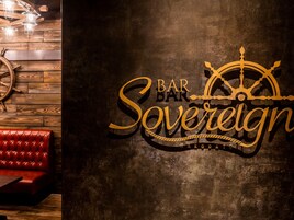 A bar sign with a ship's wheel and the words "BAR BAR Sovereign".