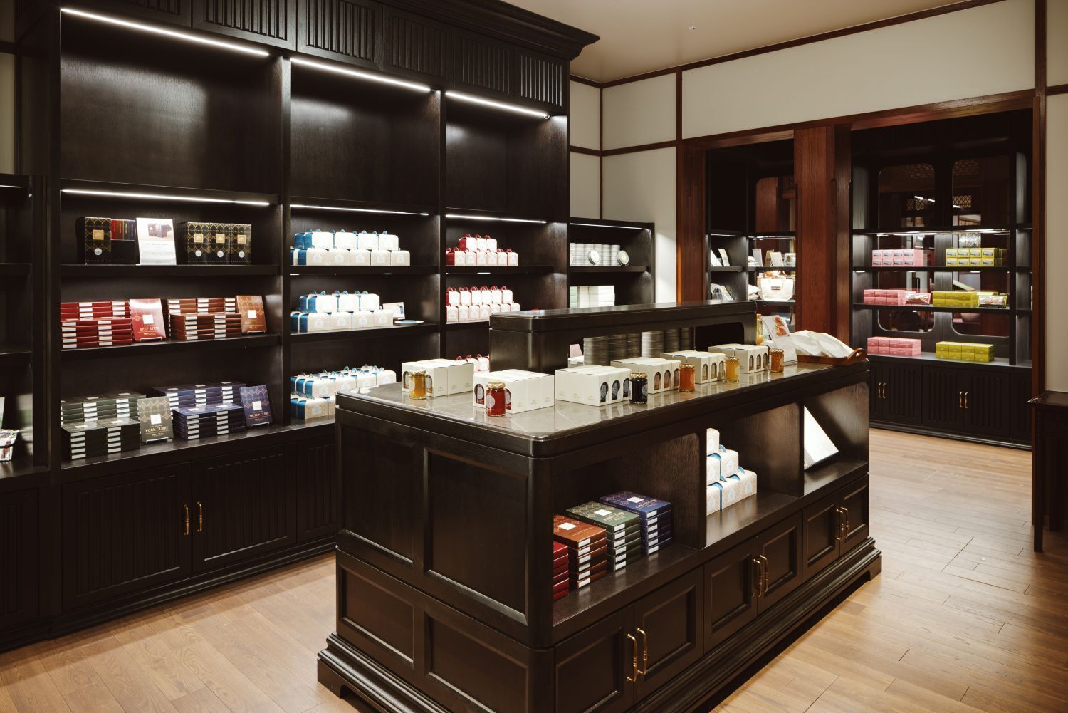 A bookstore with dark wood shelving and a central display.