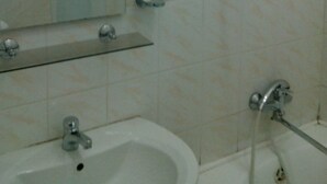 A bathroom with a sink, mirror, and shower. - Hotel  Flat 5678 (Odesa)