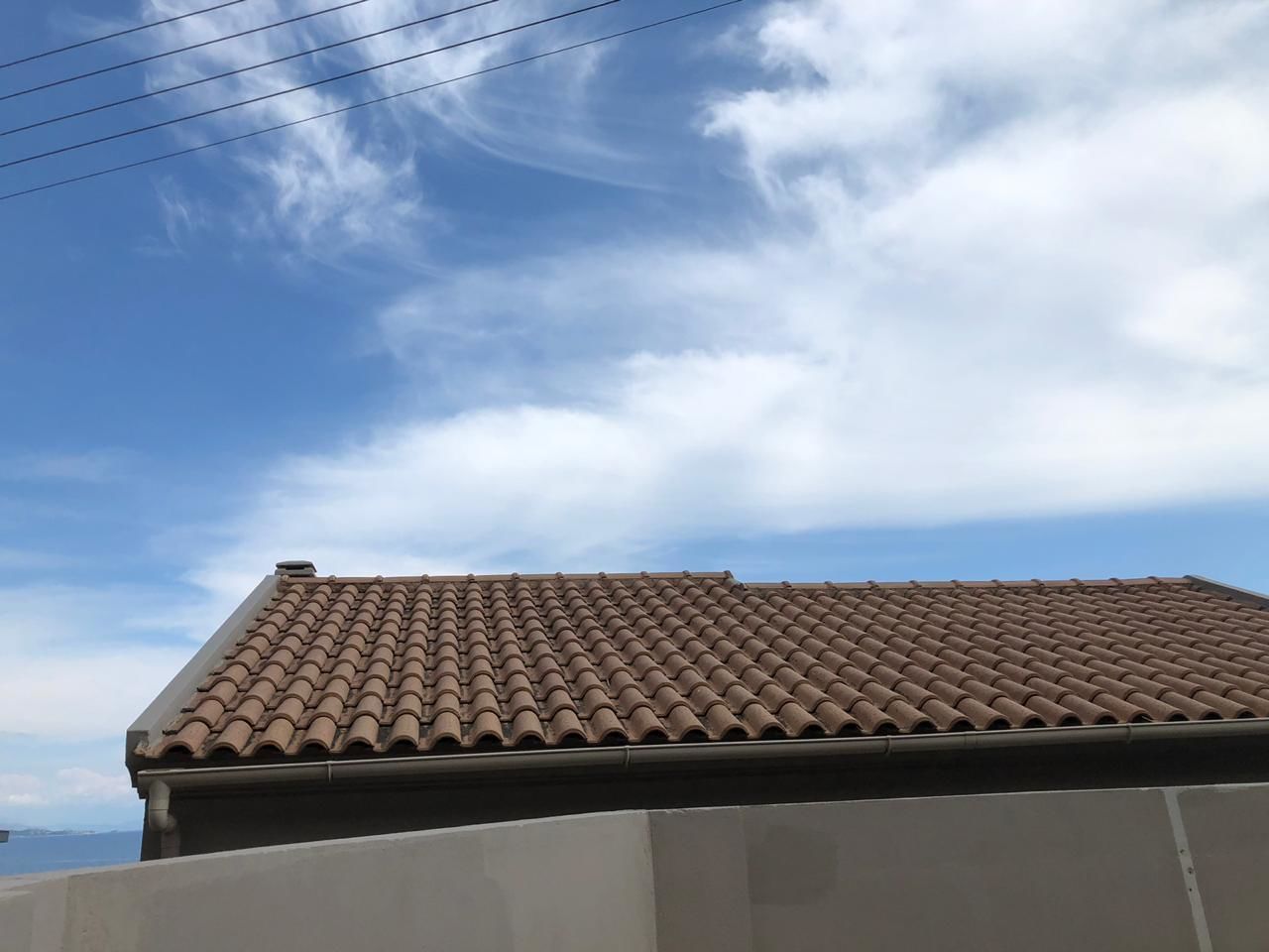 A building with a tiled roof and a clear sky.