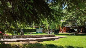 A well-maintained garden with a stone pathway, a small pond, and a gazebo. - Hotel Talabart (Les)